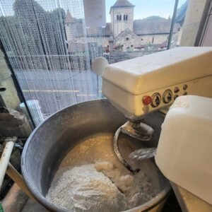 The big mixer where the dough takes shape, lit by the first light of day
